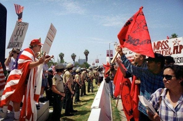 Pro (left) and con Proposition 187 activists are separated by police during a rally in Los Angeles in this file photo taken Aug. 10, 1996.